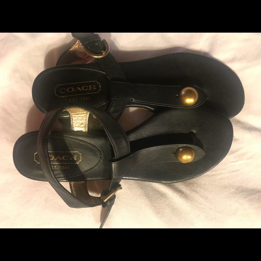 Black coach flat sandals.